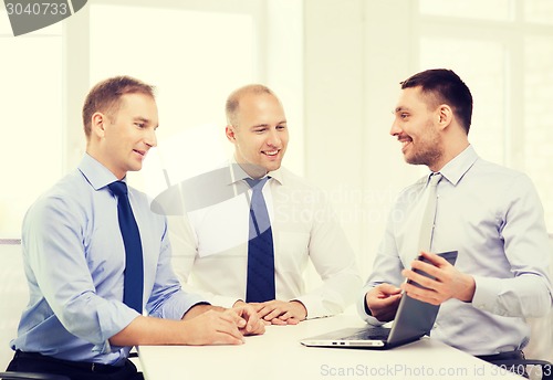 Image of business team working with laptop in office