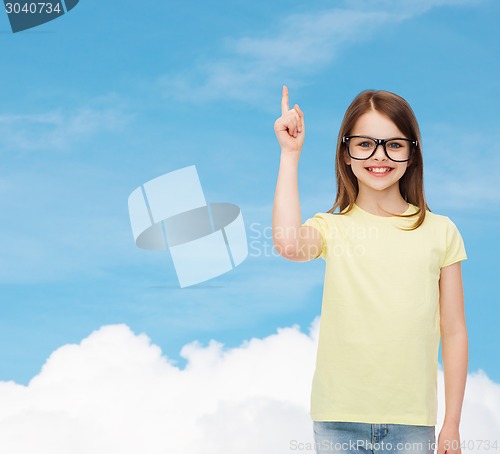 Image of smiling cute little girl in black eyeglasses