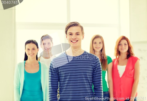 Image of smiling students with teenage boy in front