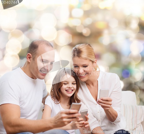 Image of happy family with smartphones