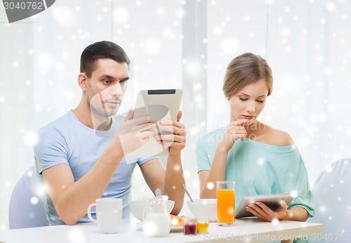 Image of couple with tablet pc having breakfast