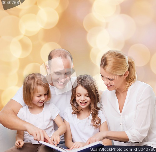 Image of happy family with book at home