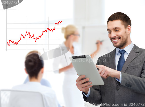 Image of young businessman showing thumbs up gesture