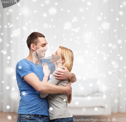 Image of happy couple hugging at home