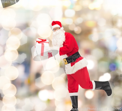 Image of man in costume of santa claus with gift box