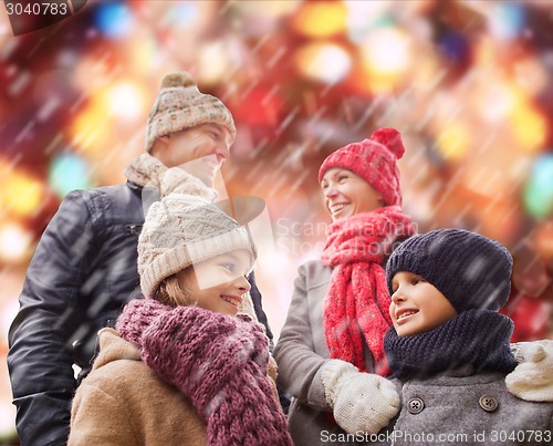 Image of happy family in winter clothes outdoors