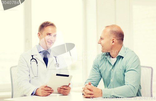 Image of doctor with tablet pc and patient in hospital