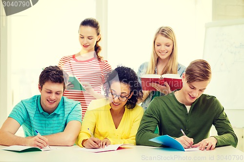 Image of students with textbooks and books at school