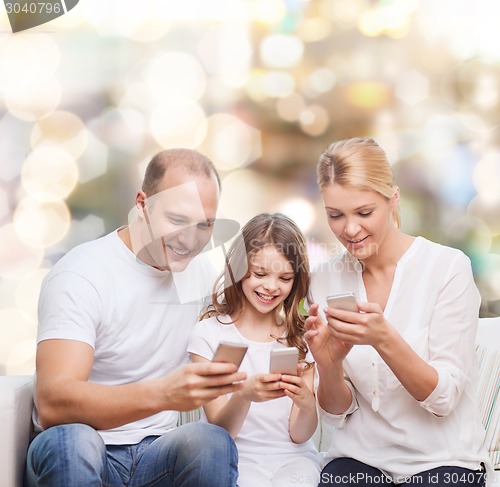 Image of happy family with smartphones