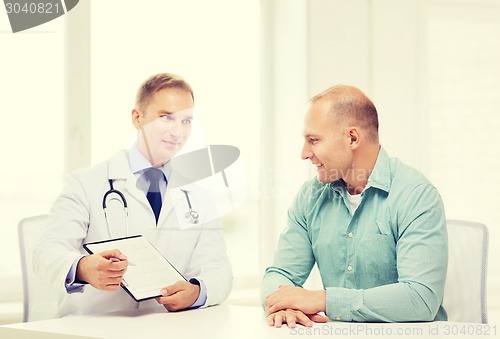 Image of doctor with clipboard and patient in hospital