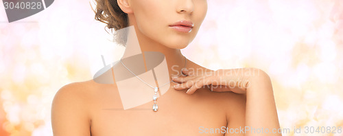 Image of woman wearing shiny diamond pendant