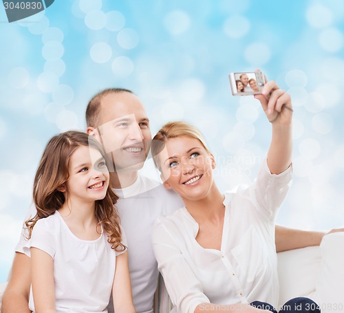 Image of happy family with camera at home