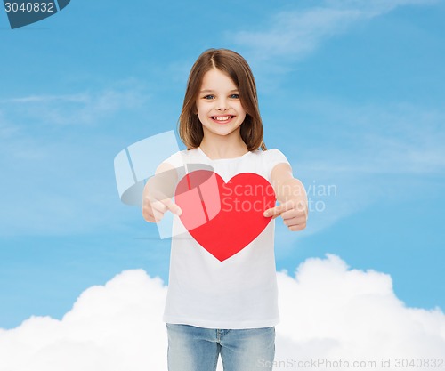 Image of beautiful little girl sitting at table