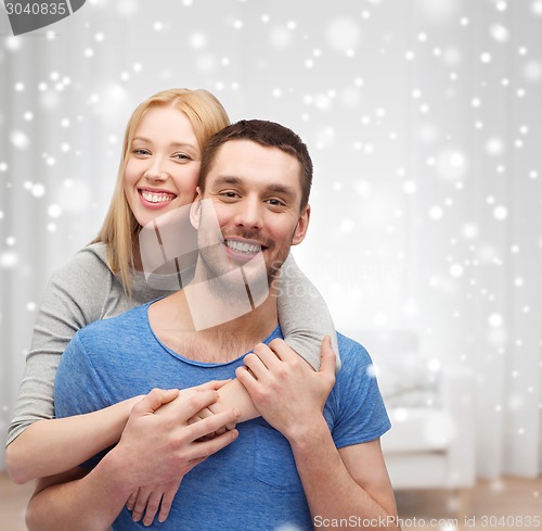 Image of happy couple hugging at home