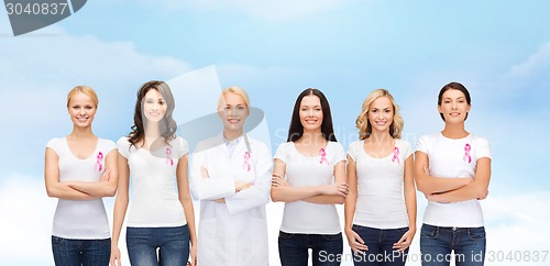 Image of smiling women with pink cancer awareness ribbons