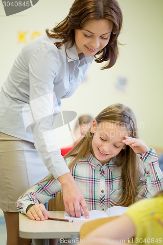 Image of group of school kids writing test in classroom