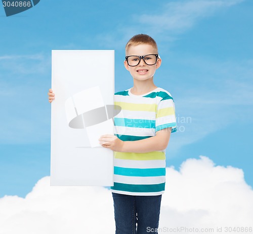 Image of smiling boy in eyeglasses with white blank board