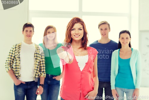 Image of students with teenager in front pointing at you