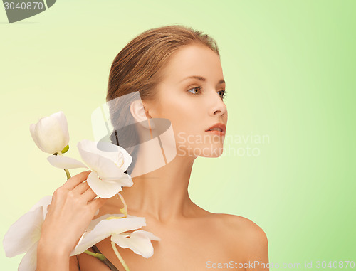 Image of beautiful young woman with orchid flowers