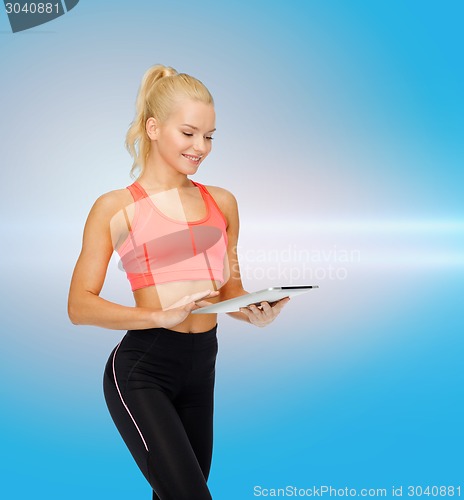 Image of smiling sporty woman with tablet pc computer