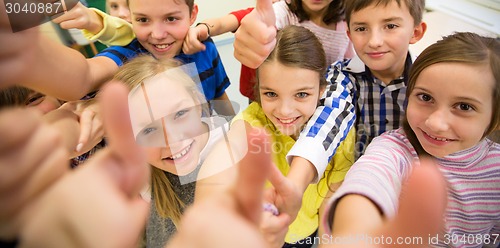 Image of group of school kids showing thumbs up