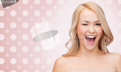 Image of beautiful young woman over polka dot background