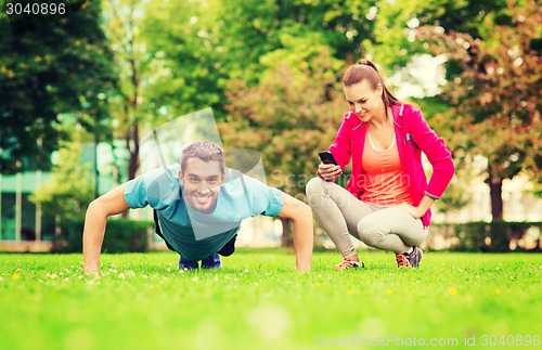 Image of smiling man doing exercise outdoors