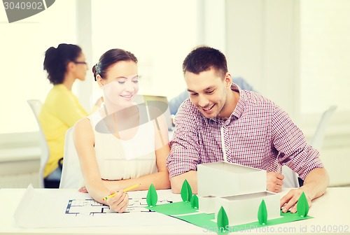 Image of smiling architects working in office