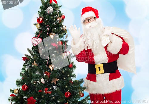 Image of santa claus with bag and christmas tree