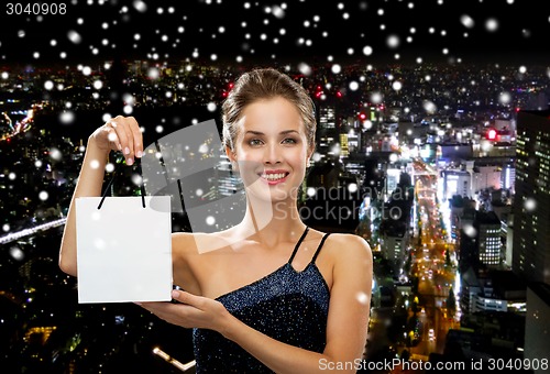 Image of smiling woman with white blank shopping bag