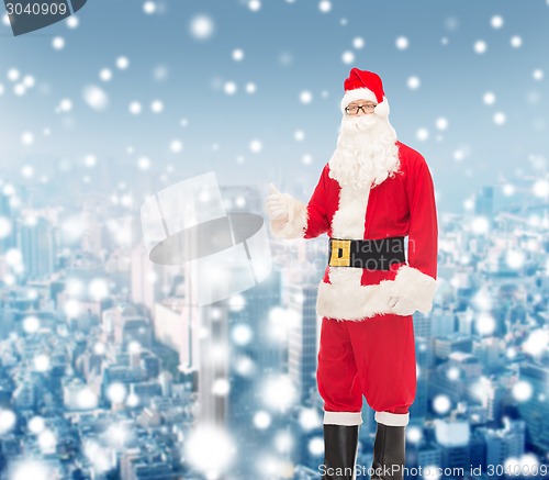 Image of man in costume of santa claus showing thumbs up