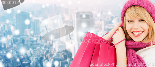 Image of smiling young woman with shopping bags