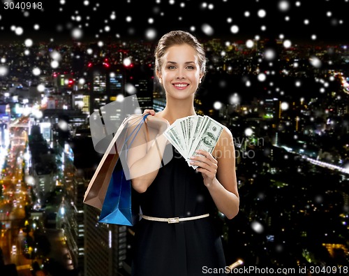 Image of smiling woman in dress with shopping bags