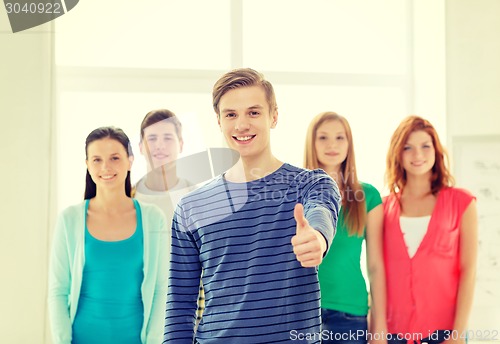 Image of smiling students with teenage boy in front