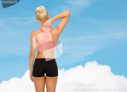 Image of sporty woman touching her neck