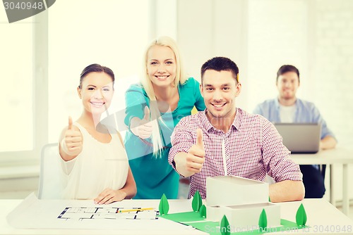 Image of smiling architects working in office