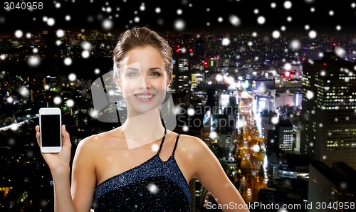 Image of smiling woman in evening dress with smartphone