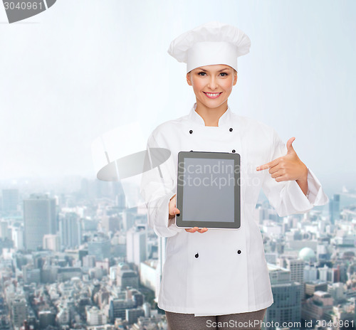 Image of smiling female chef with tablet pc blank screen