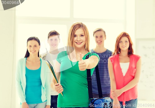 Image of smiling students with teenage girl in front