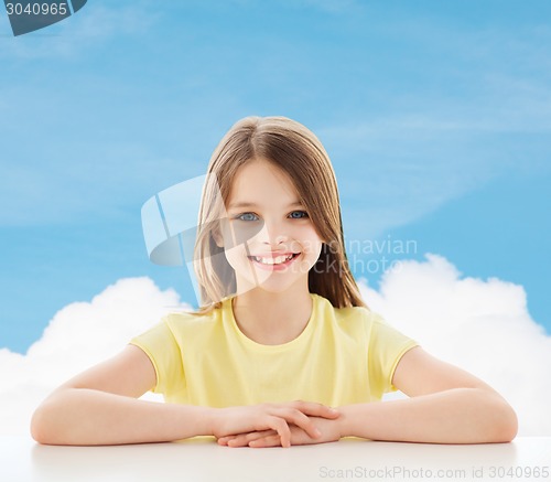 Image of beautiful little girl sitting at table