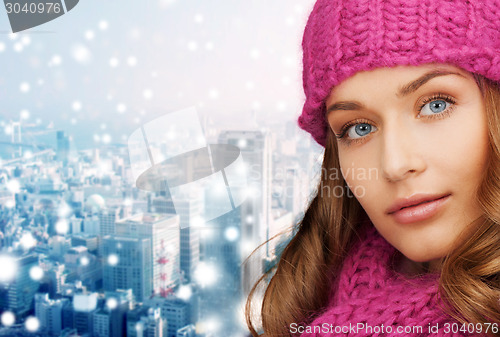 Image of close up of smiling young woman in winter clothes