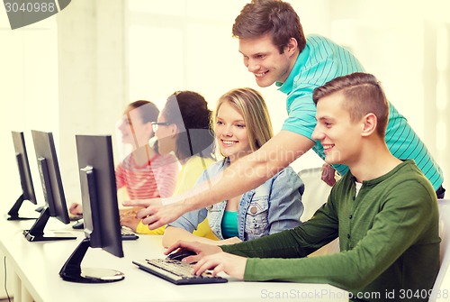 Image of smiling students in computer class at school