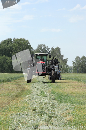 Image of combine harvester on a wheat field with a blue sky