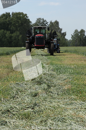 Image of combine harvester on a wheat field with a blue sky