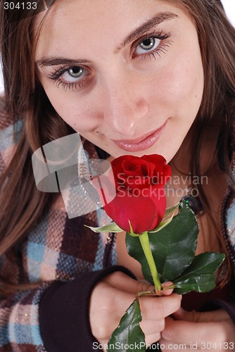 Image of Beautiful girl smelling rose