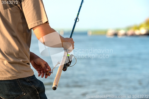 Image of Modern clean fishing rod in hands