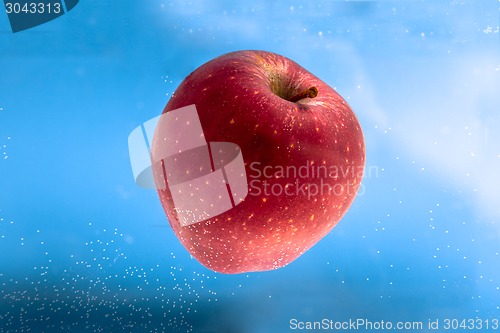 Image of Small apple in see trough water