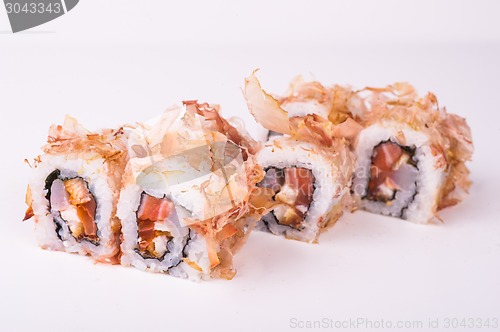 Image of salmon sushi roll in tuna flakes 