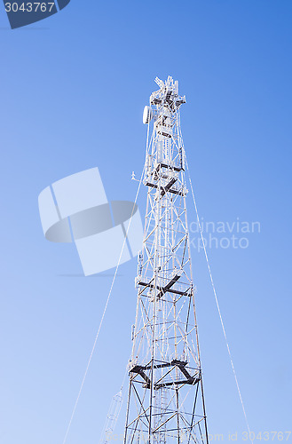 Image of Radio mast on blue frosty winter sky