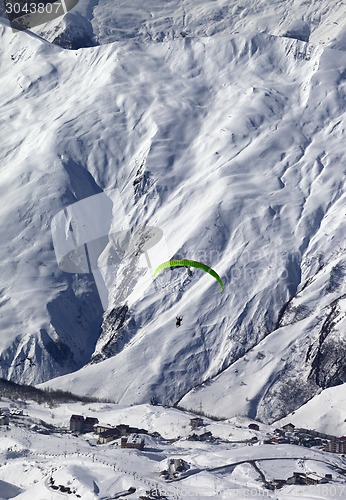 Image of Speed flying in snow mountains at sun day